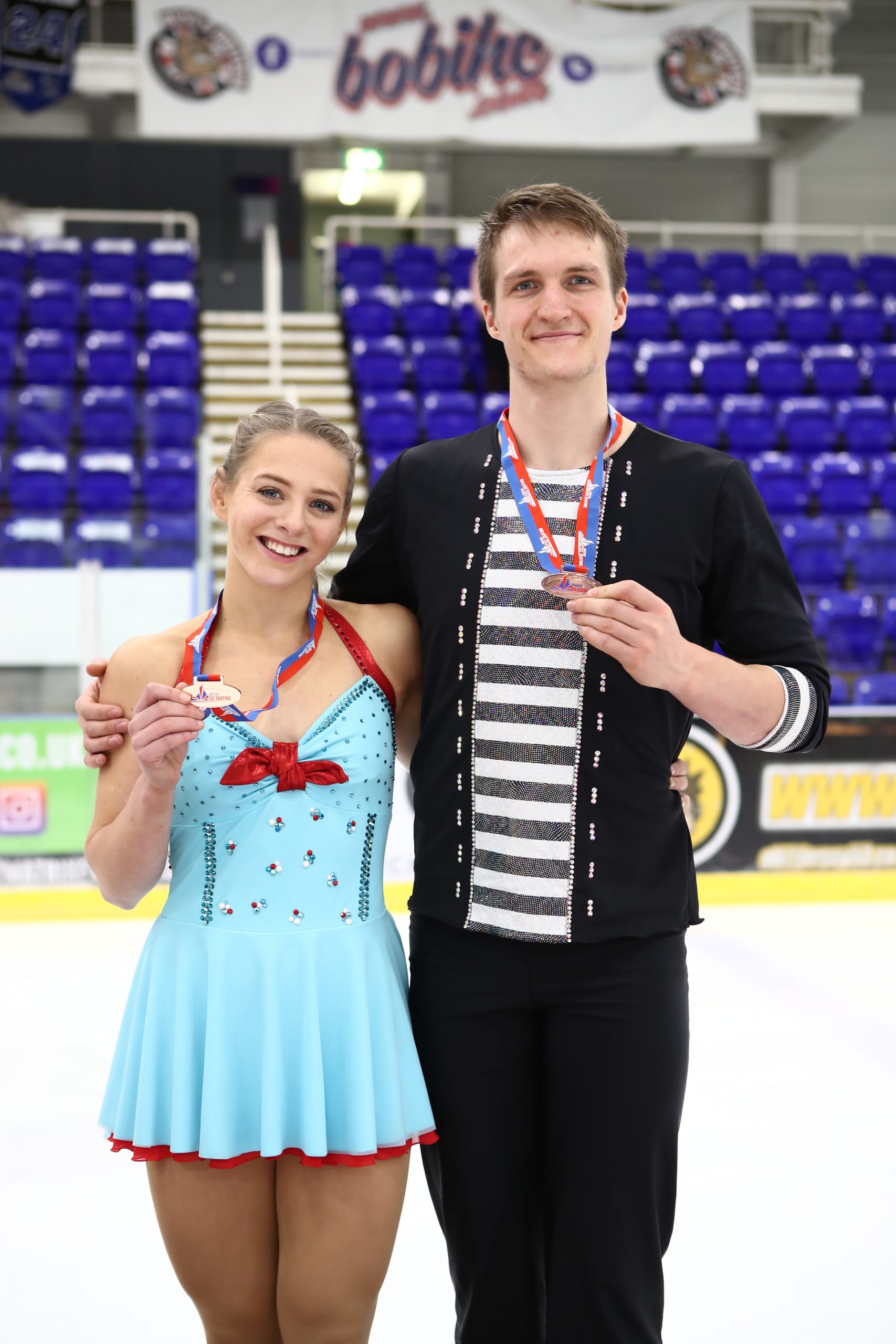 Harry Mattick and Lydia Smart holding their national championship medals.
